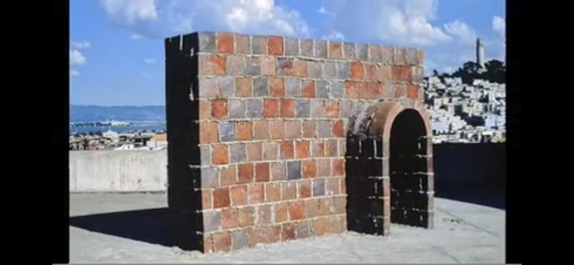 Brick archway sculpture on rooftop overlooking San Francisco